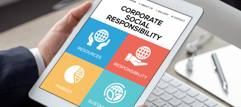 Tablet with icons and phrase Corporate Social Responsibility